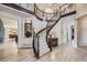 Beautiful home foyer with curved stair case, wood floors, and wrought iron at 9552 E Silent Hills Pl, Lone Tree, CO 80124