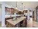 Spacious kitchen with custom wood cabinetry, a large center island, and modern appliances at 9552 E Silent Hills Pl, Lone Tree, CO 80124