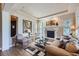 Bright living room featuring a fireplace, comfortable seating, and ample natural light at 9552 E Silent Hills Pl, Lone Tree, CO 80124