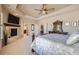 Comfortable main bedroom includes a fireplace, large dresser, and views into the en-suite bath at 9552 E Silent Hills Pl, Lone Tree, CO 80124