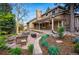 Spacious backyard with stone patio, landscaped garden beds, and comfortable seating, ideal for outdoor gatherings at 10849 E Crestridge Cir, Englewood, CO 80111