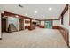 Finished basement with wooden beam accents, bar area, and walk out access at 10849 E Crestridge Cir, Englewood, CO 80111
