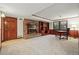 Finished basement with a brick fireplace, built-in shelving, and work space at 10849 E Crestridge Cir, Englewood, CO 80111
