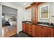 Bright bathroom with double sinks, wood cabinets, stone countertop, and decorative mirrors at 10849 E Crestridge Cir, Englewood, CO 80111