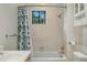 Bright bathroom features a shower over tub, decorative shower curtain, and tiled walls at 10849 E Crestridge Cir, Englewood, CO 80111