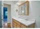 This secondary bathroom features wood cabinets, a double sink, and granite countertops at 10849 E Crestridge Cir, Englewood, CO 80111