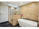 Luxurious bathroom featuring a freestanding tub, large glass enclosed shower, and stone accent wall at 10849 E Crestridge Cir, Englewood, CO 80111