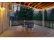 Cozy outdoor deck with dining table and chairs, illuminated by string lights, providing a relaxing setting for evening gatherings at 10849 E Crestridge Cir, Englewood, CO 80111