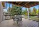 Back deck features a table with chairs and overlooks a lush green yard at 10849 E Crestridge Cir, Englewood, CO 80111