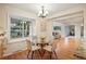 Bright breakfast nook area with a round glass table, hardwood floors, and an indoor/outdoor feel at 10849 E Crestridge Cir, Englewood, CO 80111