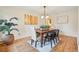 Elegant dining room with hardwood floors, a modern chandelier, and seating for six around a wooden table at 10849 E Crestridge Cir, Englewood, CO 80111