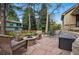 Inviting stone patio with fire pit and outdoor seating, perfect for cozy evenings and entertaining guests at 10849 E Crestridge Cir, Englewood, CO 80111