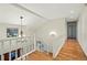 Bright hallway with hardwood floors, a staircase with white railings, and recessed lighting at 10849 E Crestridge Cir, Englewood, CO 80111