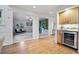 Open hallway leading to a cozy living area and office, with a view of custom cabinetry and a beverage cooler at 10849 E Crestridge Cir, Englewood, CO 80111