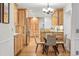 Charming kitchen with wood cabinets, granite countertops, stainless appliances, and a round glass table and chairs at 10849 E Crestridge Cir, Englewood, CO 80111