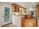 Bright kitchen with wood cabinetry, granite countertops, stainless steel appliances, and access to an outdoor patio at 10849 E Crestridge Cir, Englewood, CO 80111