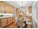 Charming kitchen featuring wood cabinets, granite countertops, stainless steel appliances and a round glass table at 10849 E Crestridge Cir, Englewood, CO 80111