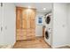 Laundry room featuring a stacked washer and dryer, wood cabinets for storage, and granite countertops at 10849 E Crestridge Cir, Englewood, CO 80111