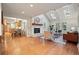 Open-concept living room featuring a beautiful fireplace, vaulted ceilings with skylights, and hardwood floors at 10849 E Crestridge Cir, Englewood, CO 80111