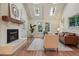 Bright living room featuring a fireplace, vaulted ceilings with skylights, hardwood floors and a cozy feel at 10849 E Crestridge Cir, Englewood, CO 80111