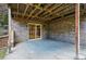 Brick patio with sliding glass door entry and exposed ceiling beams, providing a functional outdoor living space at 10849 E Crestridge Cir, Englewood, CO 80111