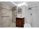 Updated bathroom featuring a tiled shower, modern vanity, and convenient built-in shelving at 3818 W 14Th Ave, Denver, CO 80204