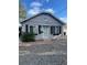 Charming home with gray exterior, well-maintained landscaping, and covered front porch at 3818 W 14Th Ave, Denver, CO 80204