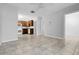 Open concept kitchen and living space with neutral tile flooring and ample natural light at 3818 W 14Th Ave, Denver, CO 80204