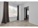 Bright room with neutral tile floors, large window, and built-in storage at 3818 W 14Th Ave, Denver, CO 80204