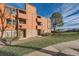 Exterior view of condo featuring balconies, stone accents, wood siding, and well-maintained landscaping at 4294 S Salida Way # 4, Aurora, CO 80013