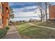 Exterior showing sidewalk winding around the condo with green lawn and several parked cars at 4294 S Salida Way # 4, Aurora, CO 80013