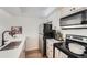 Well-lit kitchen with stainless steel appliances, modern countertops, and black fixtures at 4294 S Salida Way # 4, Aurora, CO 80013