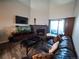 Spacious living room features a fireplace, large windows and leather seating at 11105 E Alameda Ave # 202, Aurora, CO 80012