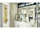 Elegant bathroom features a large mirror, double vanity, and convenient bath and shower at 14877 Arbor W Blvd, Thornton, CO 80602