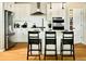 Bright kitchen with stainless steel appliances, a breakfast bar island, and white cabinets at 14877 Arbor W Blvd, Thornton, CO 80602