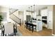 Bright, modern kitchen featuring stainless steel appliances, white cabinetry, and a breakfast bar and dining room combo at 14877 Arbor W Blvd, Thornton, CO 80602