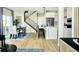 Bright and airy kitchen with a dining area, modern appliances, island seating and a view to the staircase at 14877 Arbor W Blvd, Thornton, CO 80602