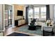 Bright living room featuring a modern sofa, coffee table, a black tv console and decor at 14877 Arbor W Blvd, Thornton, CO 80602