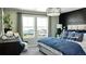 Bright main bedroom featuring mountain views, stylish decor, and large windows at 14877 Arbor W Blvd, Thornton, CO 80602