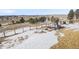 Spacious backyard with a wooden playset and fenced perimeter in a snowy landscape at 20290 Doewood Dr, Monument, CO 80132