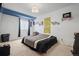 Bedroom with carpeted floors, blue trim, a ceiling light fixture, and a large window at 20290 Doewood Dr, Monument, CO 80132