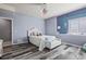 This bedroom features a white bedframe, gray wood floors, and a blue accent wall at 20290 Doewood Dr, Monument, CO 80132