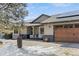 Charming house with a beautiful garage door, covered porch, and solar panels stands out in the neighborhood at 20290 Doewood Dr, Monument, CO 80132