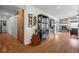 Elegant hallway with hardwood floors connects to a cozy living area featuring a stone fireplace at 20290 Doewood Dr, Monument, CO 80132