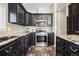 Well-appointed kitchen featuring modern appliances, dark cabinets, and a tile backsplash at 20290 Doewood Dr, Monument, CO 80132