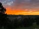 Vibrant sunset over a peaceful landscape with trees and fields at 20290 Doewood Dr, Monument, CO 80132