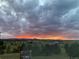 Beautiful landscape at sunset with green fields, trees, and a dramatic sky at 20290 Doewood Dr, Monument, CO 80132