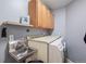 Functional laundry room featuring a stainless steel sink, countertop space, and storage cabinets at 20290 Doewood Dr, Monument, CO 80132