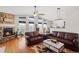 Inviting living room with a cozy stone fireplace, high ceilings, and plenty of natural light at 20290 Doewood Dr, Monument, CO 80132