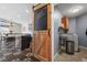 Mud room including laundry area with utility sink and sliding barn door at 20290 Doewood Dr, Monument, CO 80132